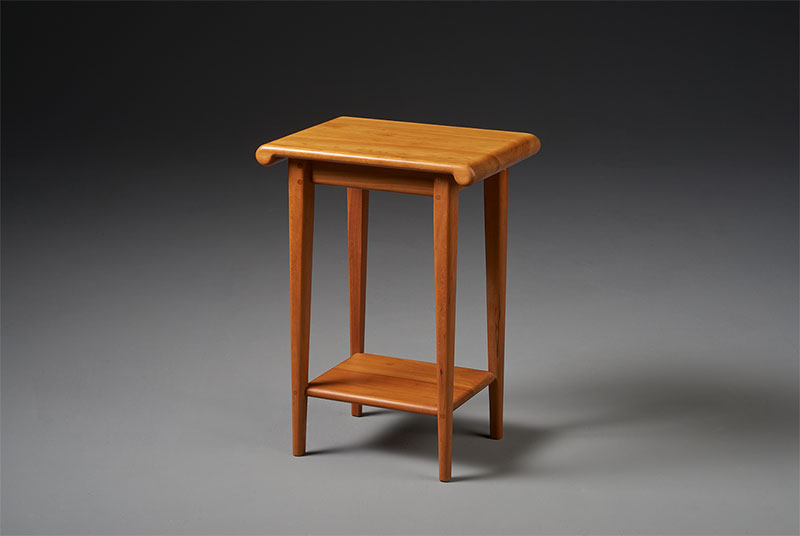 simple wood end table with  curved top and shelf