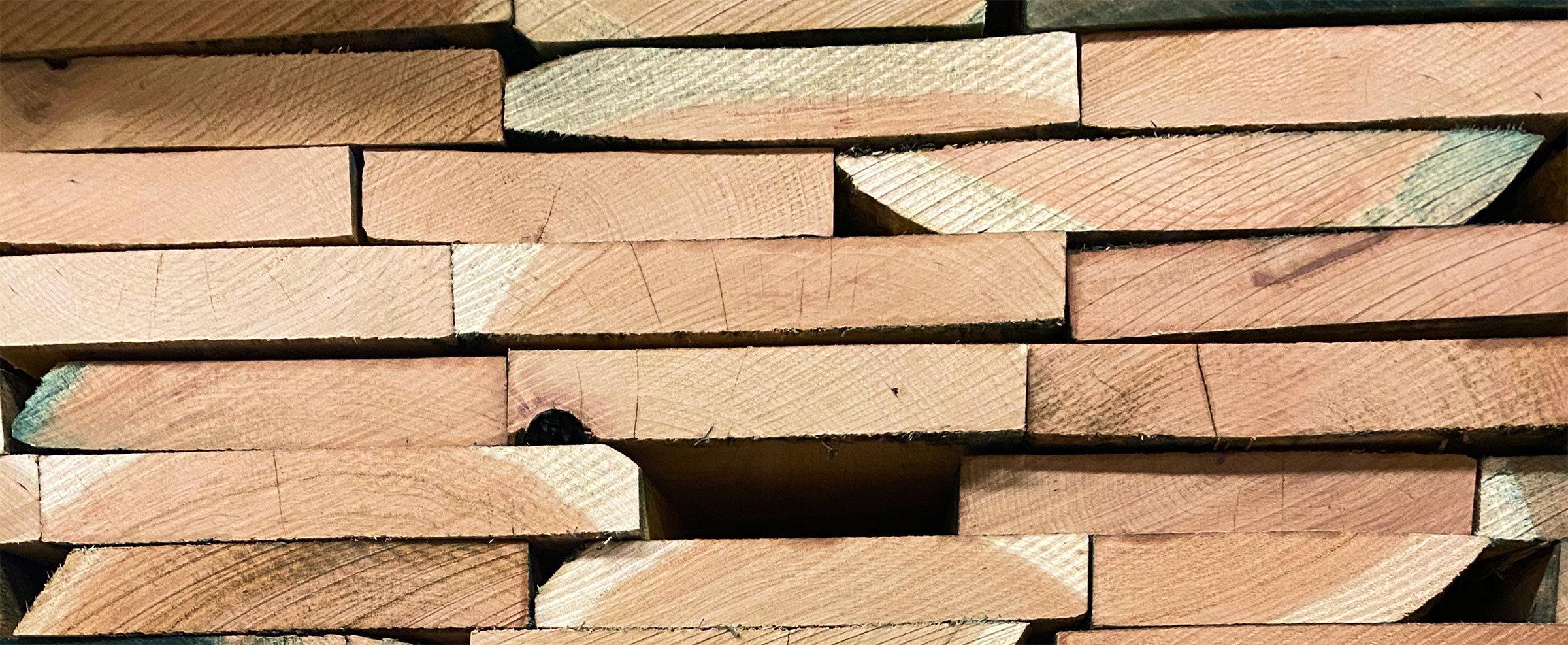 looking from the side at a pile of raw lumber